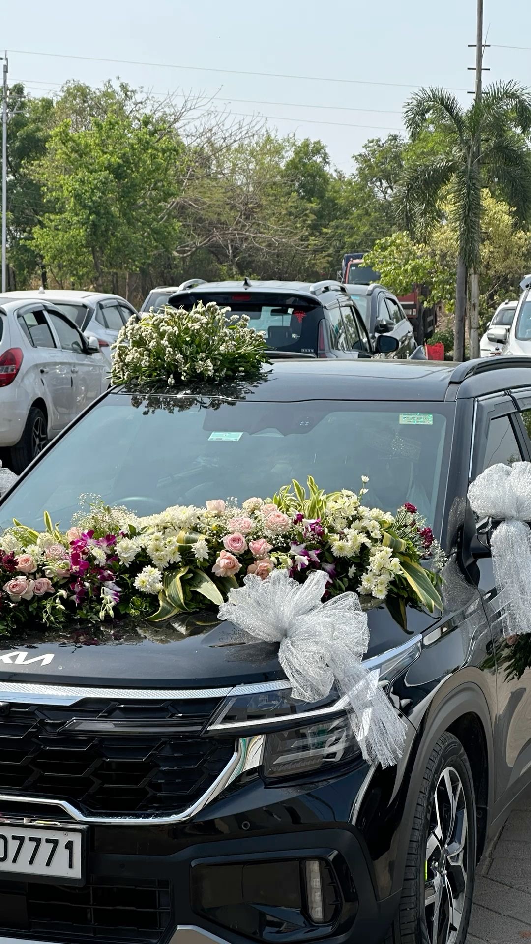Black SUV decorated with white and pink flowers