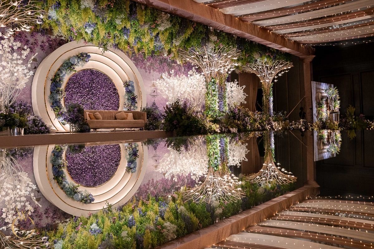 Large garden reception stage reflected in a glossy floor