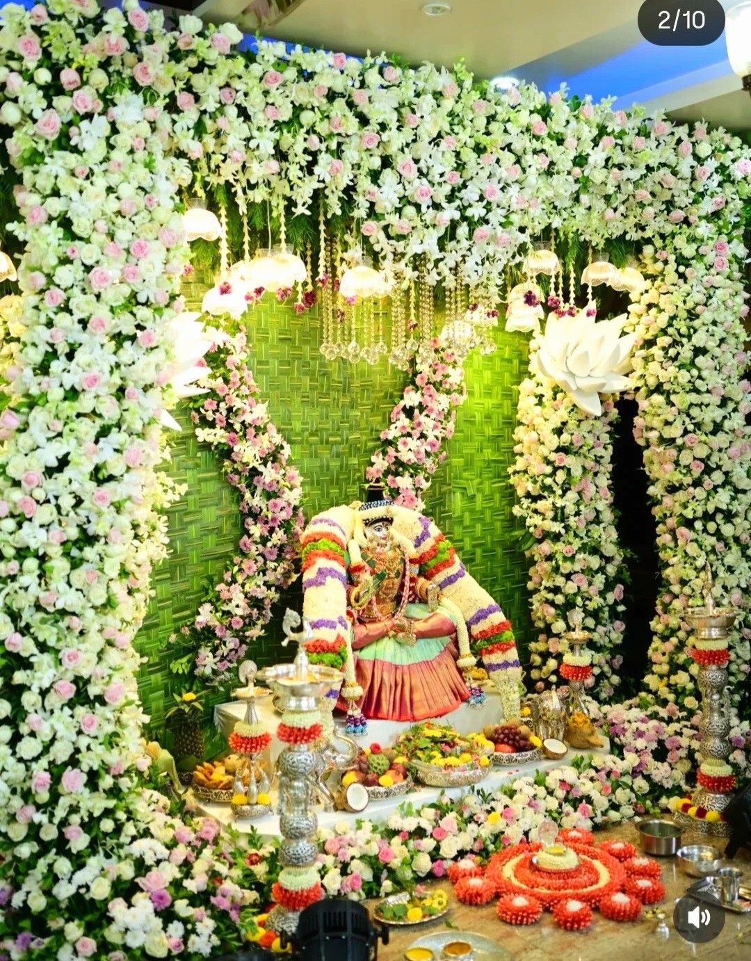 Traditional temple altar surrounded by white and pink flowers